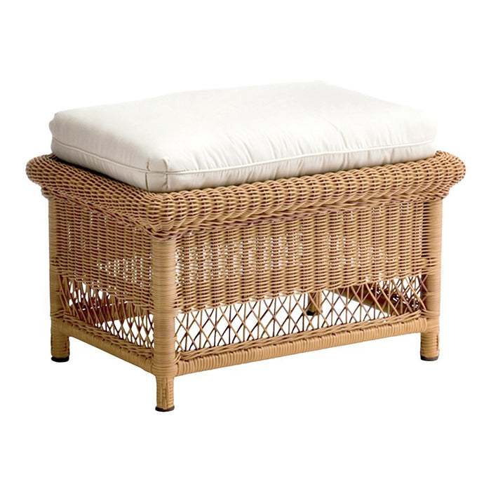 Natural woven wicker ottoman with a cream cushion topper, featuring a textured pattern and warm neutral tones.