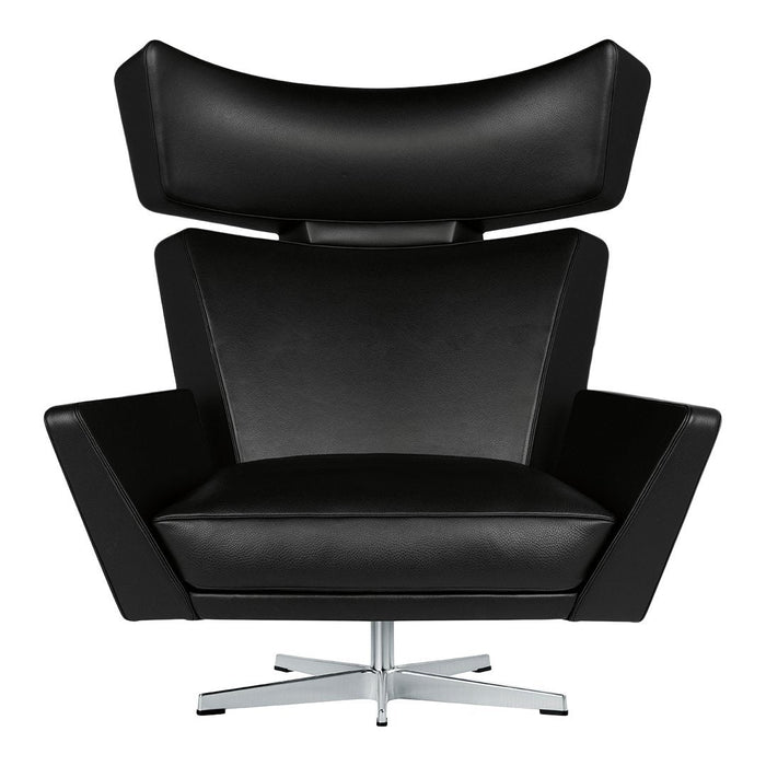 Modern black leather armchair with sleek lines and a high back design, featuring a shiny chrome base.