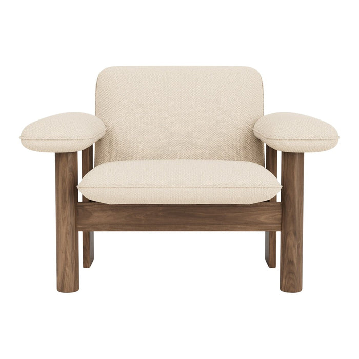 Cream-colored armchair with natural walnut wood legs and arms, featuring a simple, modern design.