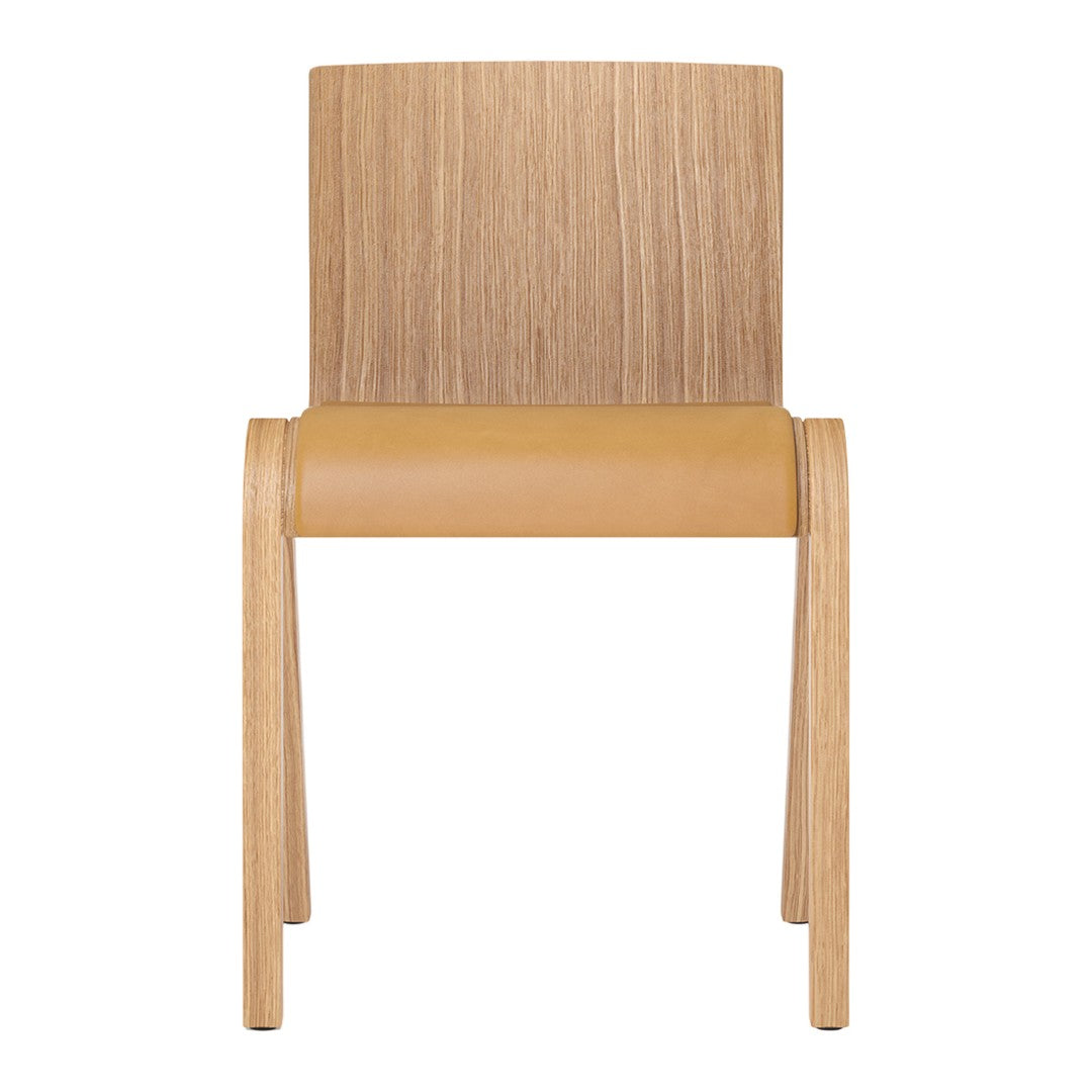 Natural wood chair with a light wood frame and a smooth tan seat, showcasing a simple, modern design.