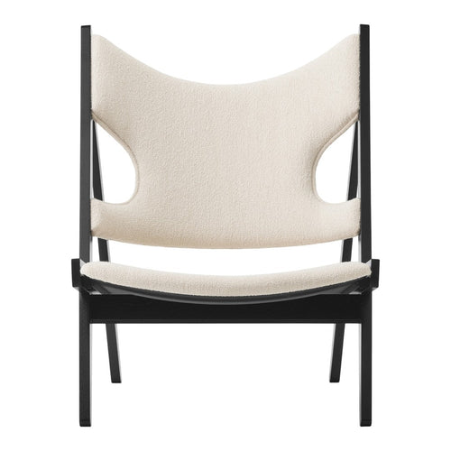 Neutral beige upholstery with a minimalist black frame; modern and stylish chair design.