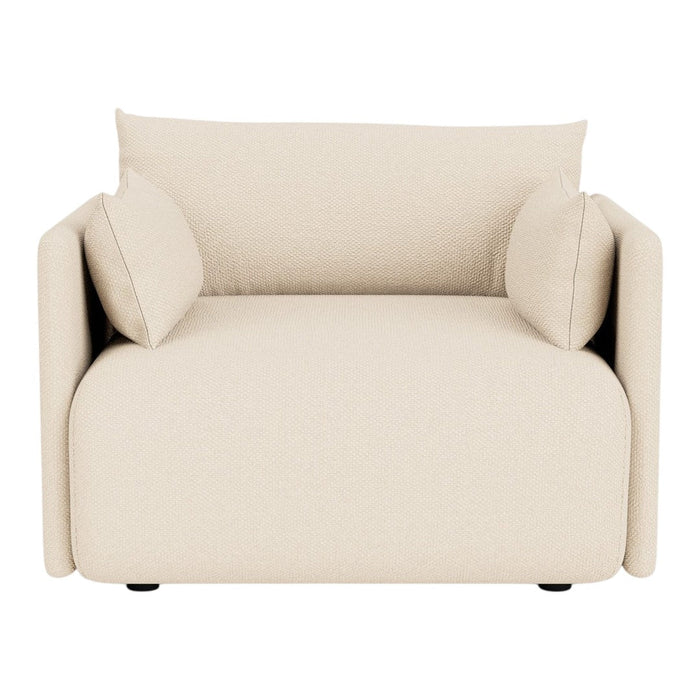 Beige upholstered armchair with two matching cushions and a smooth, modern design. Perfect for any stylish living space.