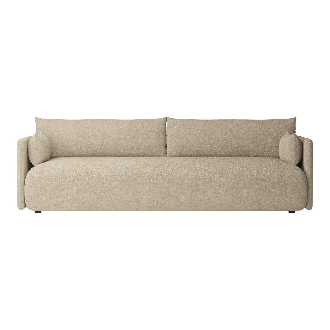 Beige fabric sofa with smooth upholstery and rounded cushions, ideal for modern living spaces.