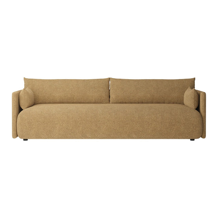 Tan fabric sofa with smooth texture, featuring simple, modern lines and round cushions for added comfort.