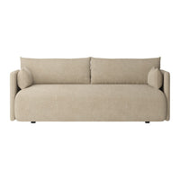 Beige upholstered sofa with smooth texture and minimalistic design, featuring round armrests and matching cushions.