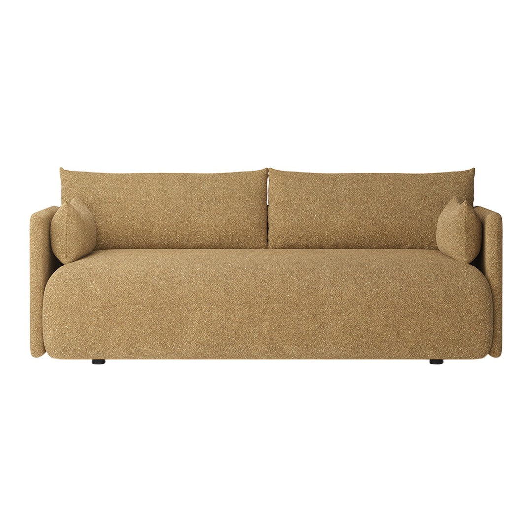 Beige sofa with a textured fabric, featuring rounded edges and two matching pillows for a cozy look.