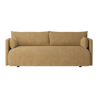 Beige sofa with a textured fabric, featuring rounded edges and two matching pillows for a cozy look.