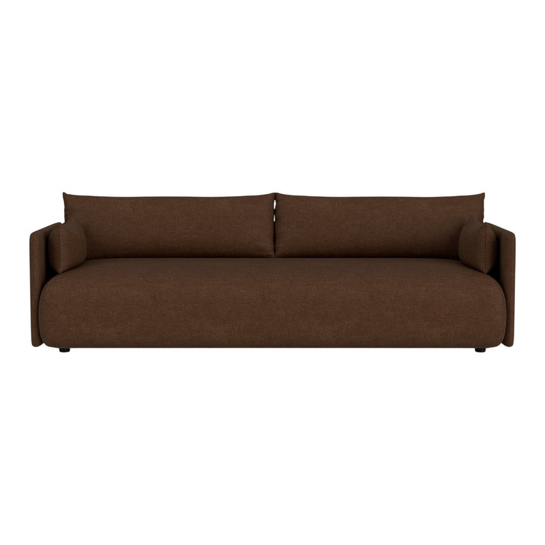 Brown sofa with a smooth texture and minimalist design, featuring two matching cylindrical pillows.