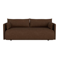 Brown upholstered sofa with a smooth texture and modern design, featuring round armrests and removable cushions.