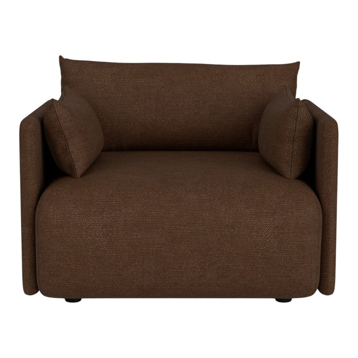 Brown upholstered armchair with soft cushions and a modern, minimalistic design, perfect for cozy spaces.