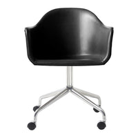 Black molded chair with smooth finish, featuring a shiny silver base and rolling wheels for easy mobility.
