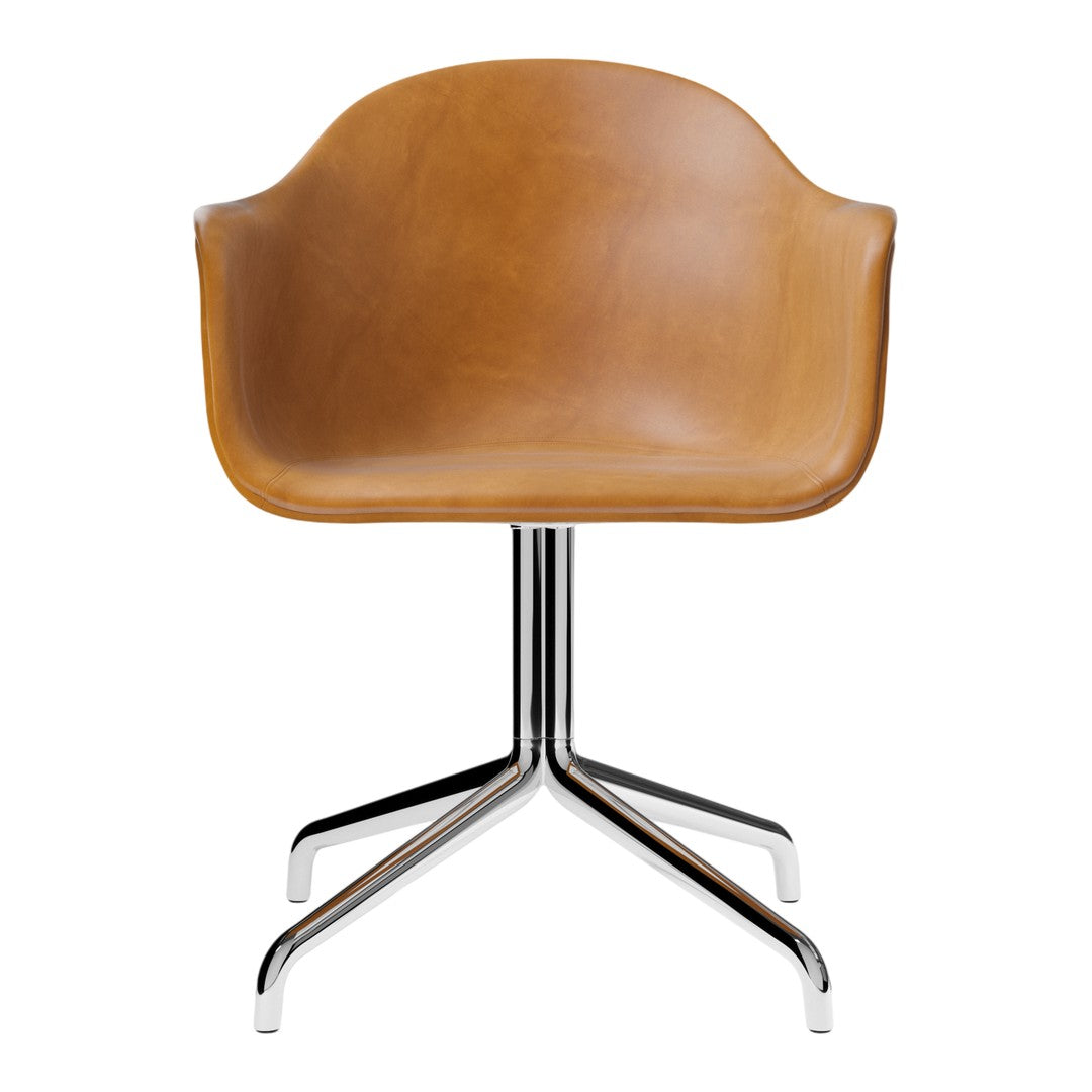 Tan leather chair with a smooth finish, featuring a sleek chrome base and minimalist design. Perfect for modern decor.