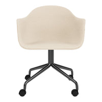 Beige upholstered chair with a smooth texture and a sleek black metal base on rolling casters.