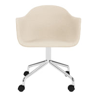 Beige upholstered chair with smooth fabric and chrome base, featuring a minimalist design and rolling casters.