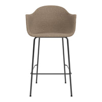 Tan textured bar stool with a sleek black metal frame, perfect for modern decor.