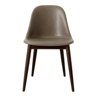 Brown upholstered chair with a smooth surface and dark wooden legs, featuring a minimalist design.
