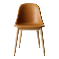 Brown leather chair with smooth surface and light wooden legs, featuring a minimalist design and curved backrest.