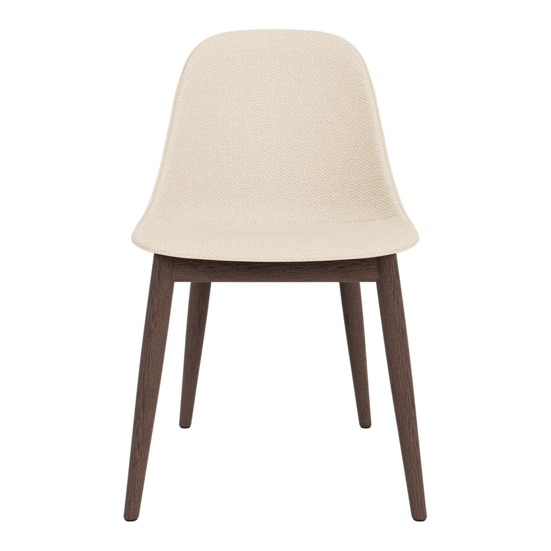 Beige molded chair with dark wooden legs, featuring a minimalist design and smooth texture. Perfect for modern decor.
