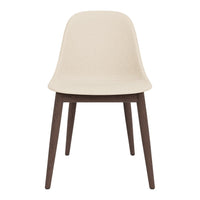 Beige molded chair with dark wooden legs, featuring a minimalist design and smooth texture. Perfect for modern decor.