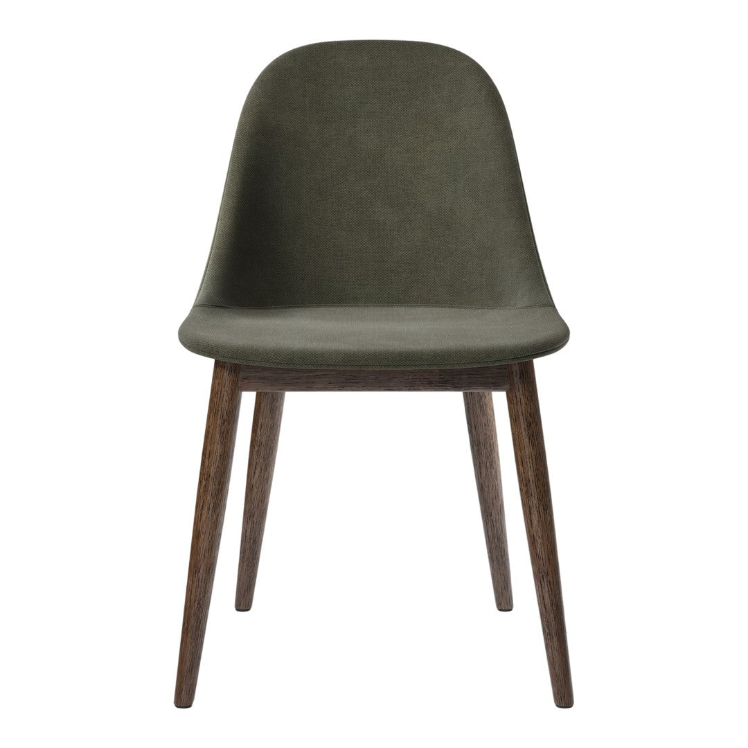 Green upholstered chair with smooth contours and wooden legs, featuring a modern, minimalist design.