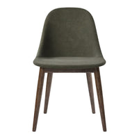 Green upholstered chair with smooth contours and wooden legs, featuring a modern, minimalist design.
