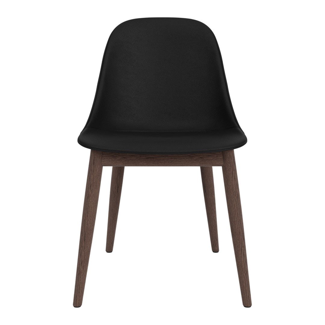 Black chair with a smooth finish and natural wood legs, featuring a minimalist design.