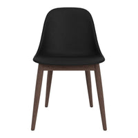 Black chair with a smooth finish and natural wood legs, featuring a minimalist design.