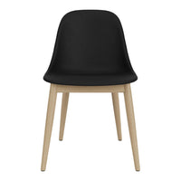 Black chair with a smooth finish, featuring natural wood legs. Modern design with minimalist style.