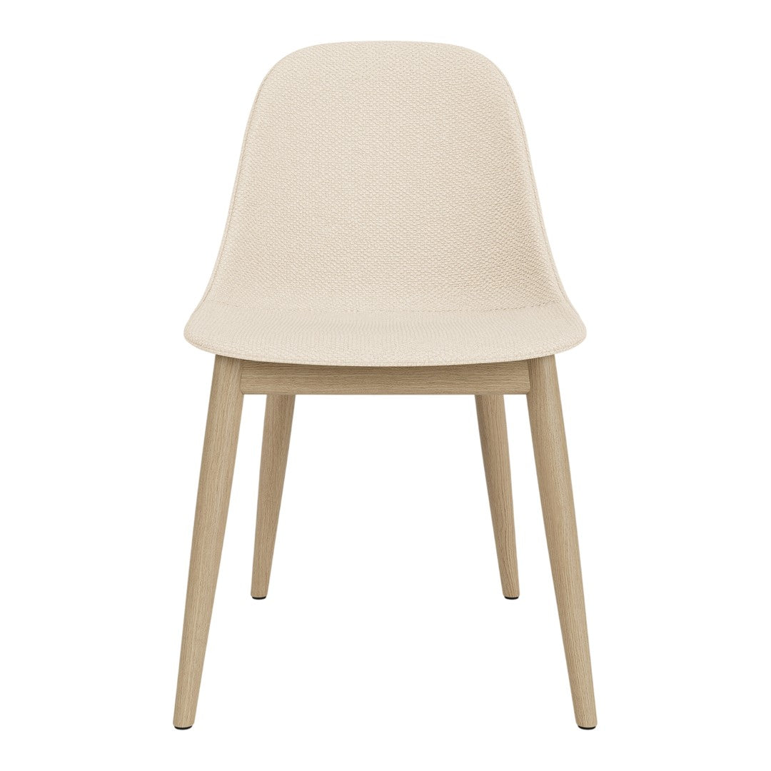Beige chair with a smooth, matte finish and natural wooden legs, showcasing minimalist design and modern aesthetics.