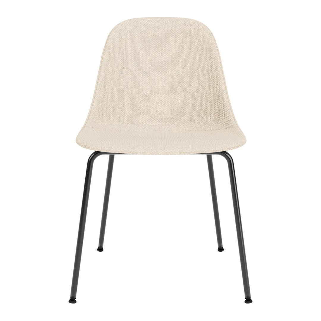 Light beige chair with a smooth, minimalist design and sleek black metal legs. Perfect for modern decor.