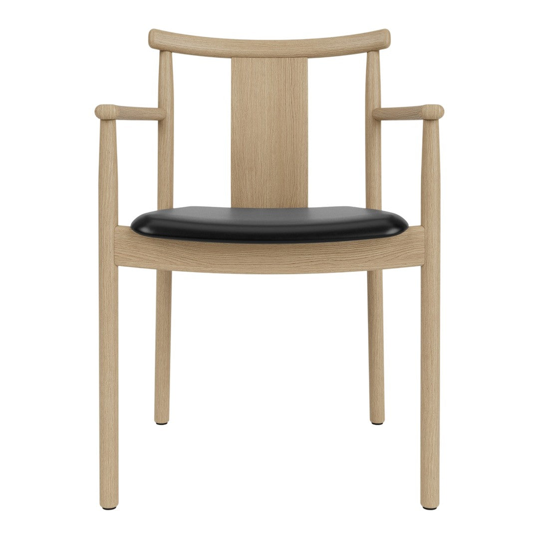 Light oak wooden chair with black seat cushion and minimalist design, featuring straight lines and smooth curves.