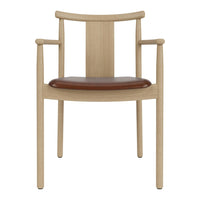 Light wood dining chair with a sleek design and a rich brown leather seat, showcasing a minimalist aesthetic.