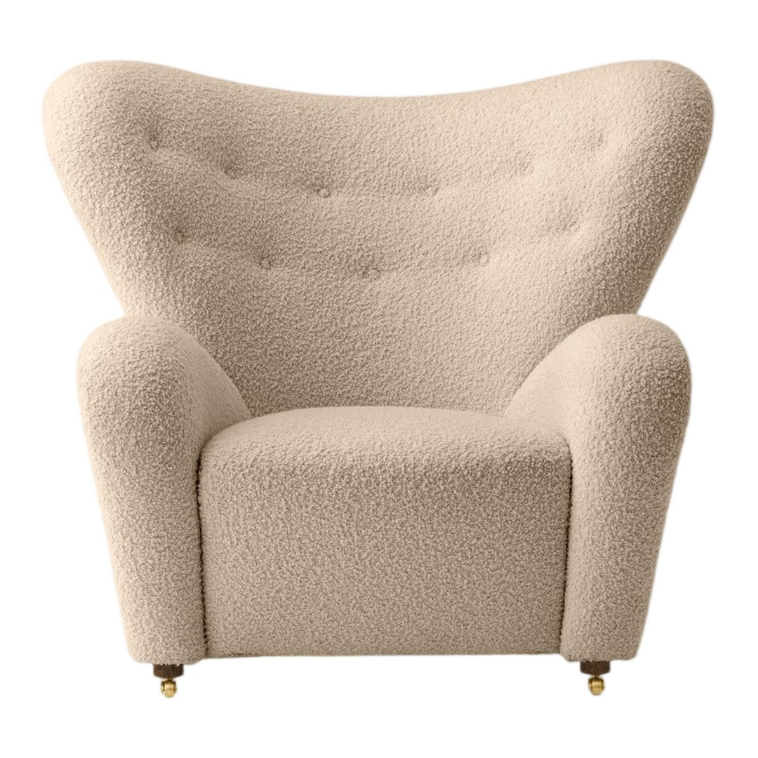 Beige upholstered armchair with textured boucle fabric and tufted buttons, featuring a stylish, curved silhouette.