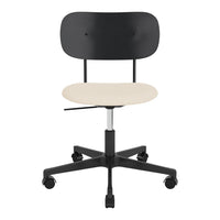 Black ergonomic office chair with a smooth beige seat and a sleek modern design. Perfect for minimalist decor.