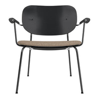 Black metal chair with a beige textured fabric seat, featuring a minimalist design and smooth curves.