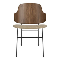 Modern chair with a walnut wood back, beige seat cushion, and sleek black metal legs, showcasing a minimalist design.