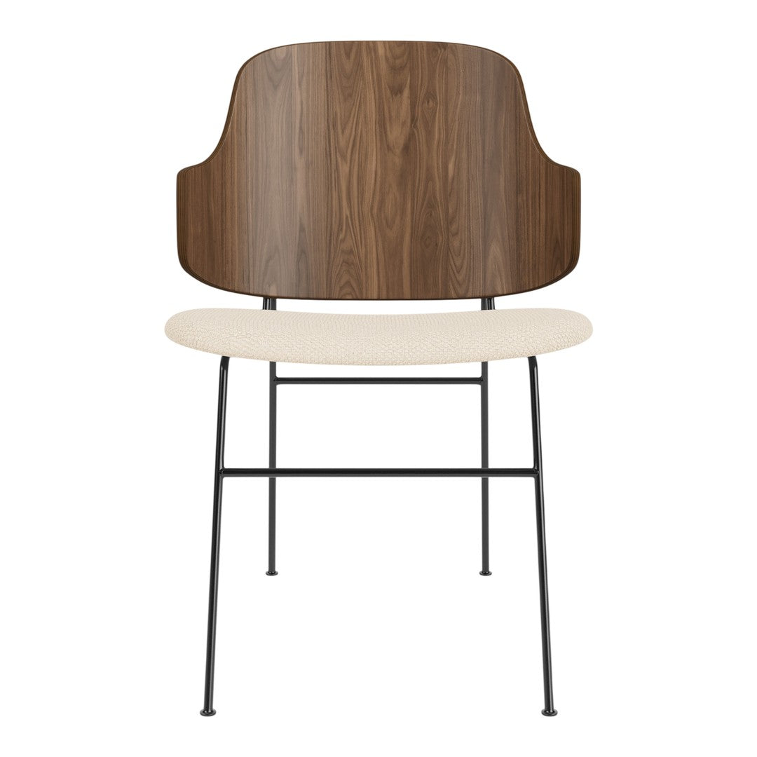 Modern chair featuring a walnut wood back, cream seat, and sleek black metal legs. Elegant and minimalist design.