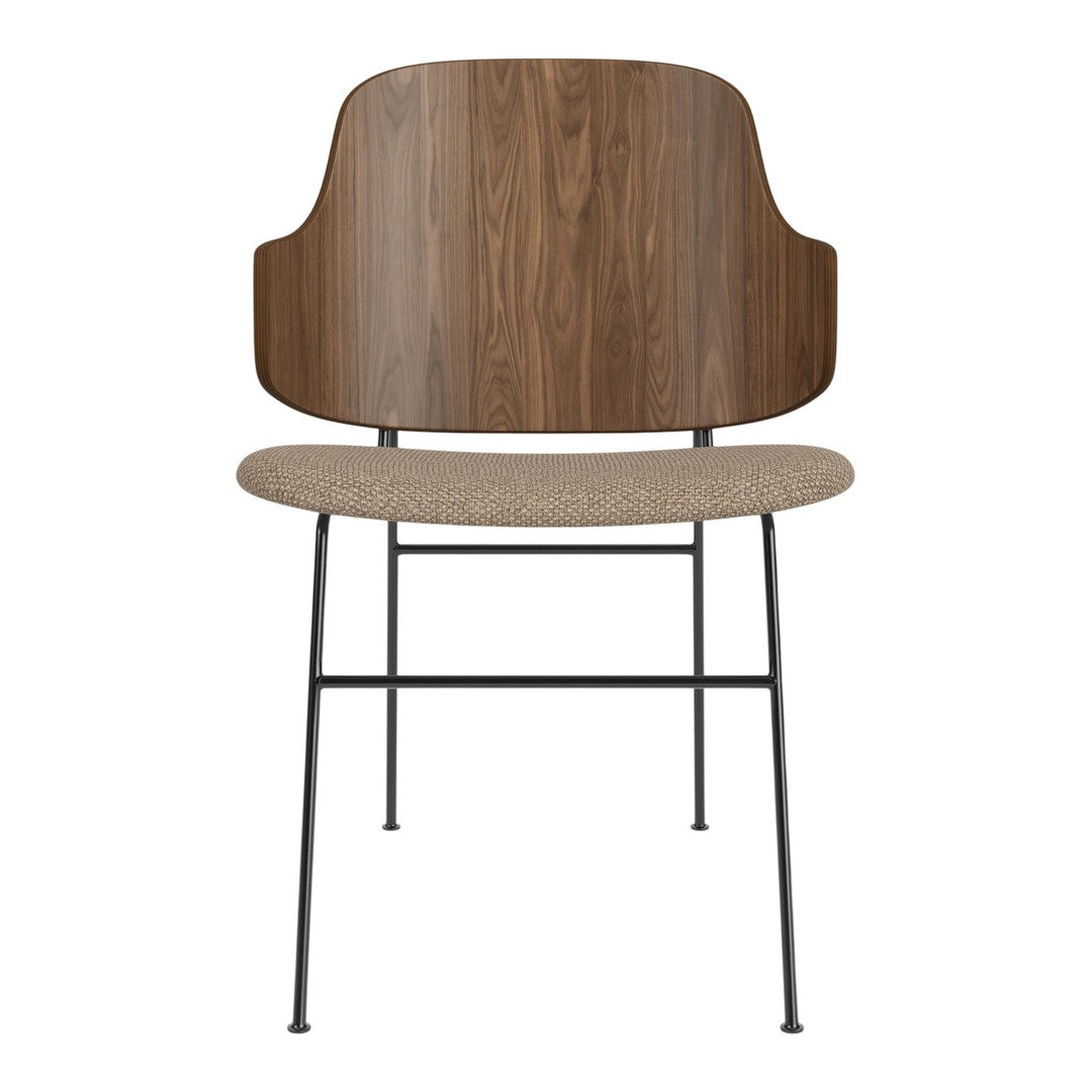 Modern chair with a walnut wood back, beige seat, and black metal legs. Elegant design with natural tones.