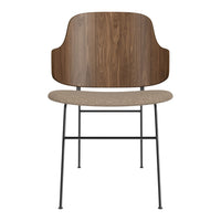 Modern chair with a walnut wood back, beige seat, and black metal legs. Elegant design with natural tones.