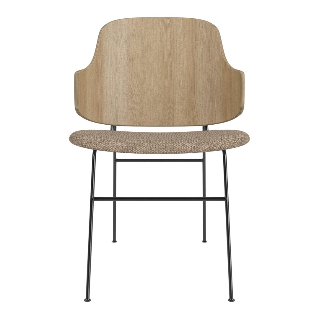 Light wood chair with a textured beige seat and black metal legs, combining modern minimalism with natural tones.