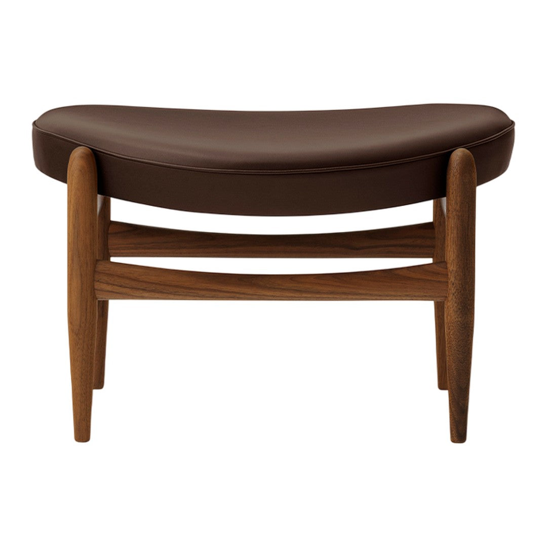 Brown curved leather upholstery with a warm wood frame, featuring minimalist design and smooth lines.