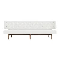 White tufted sofa with colorful button accents and a wooden frame, perfect for modern decor.