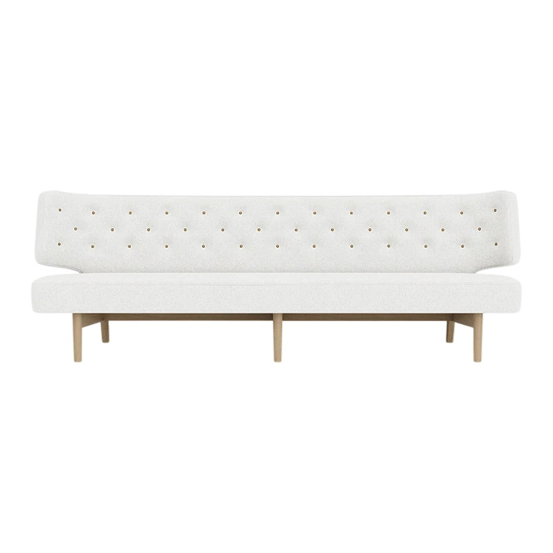 Elegant white tufted sofa with colorful button accents and natural wood legs, perfect for modern living spaces.
