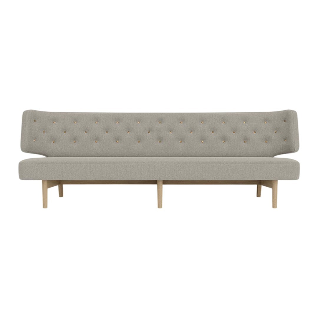 Gray tufted sofa with a sleek design and natural wood legs, creating a modern and minimalist aesthetic.