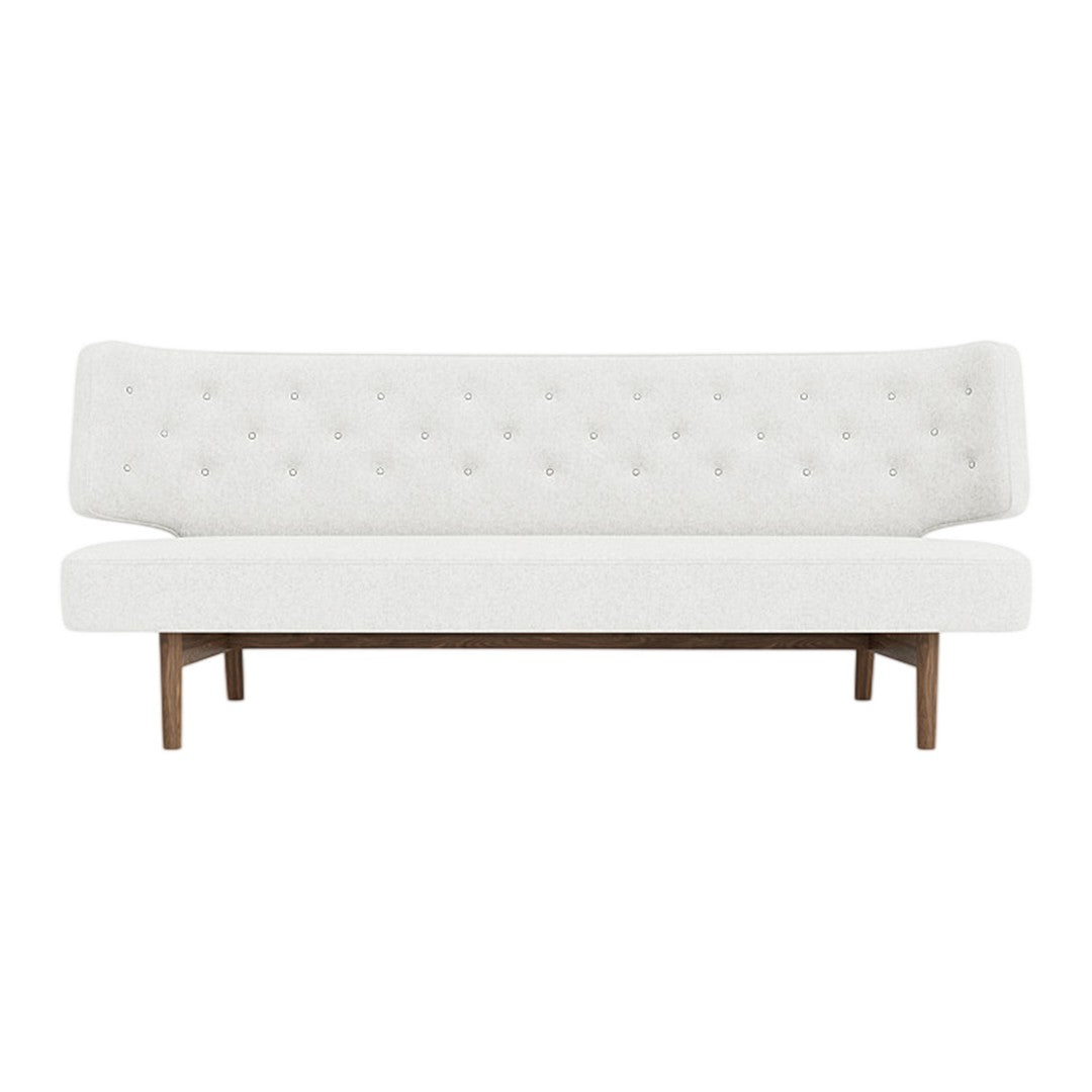 Elegant white sofa with tufted upholstery and wooden legs, perfect for modern decor.