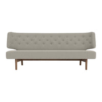 Light gray tufted sofa with a sleek wooden frame, featuring a minimalist design and smooth upholstery.