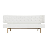White tufted sofa with a minimalist design and wooden legs, perfect for modern decor.