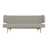Light gray tufted sofa with a minimalist design and wooden legs, perfect for modern interiors.
