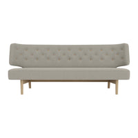 Light grey tufted sofa with a minimalist design and natural wood legs. Perfect for modern interiors.