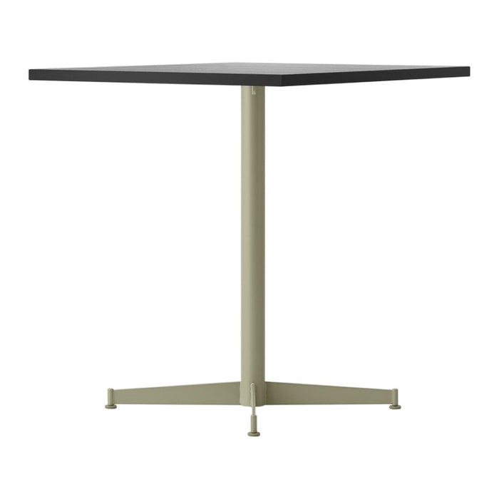 Square table featuring a matte black top and a light olive green base, minimalist design with clean lines.